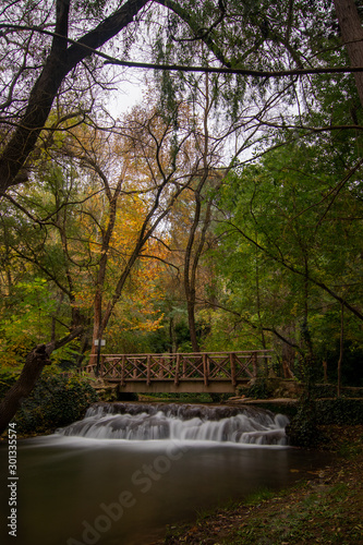 river with waterfall in the autumn season