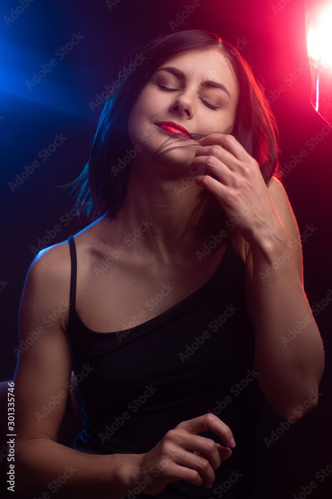 beautiful girl in the light of colored lamps beautiful girl in the light of colored lamps