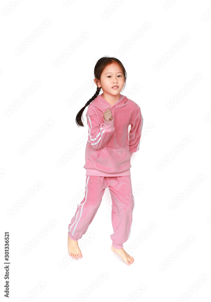 Little Asian child girl in pink tracksuit or sport cloth running isolated on white background. Freedom and sport kid movement concept. Little Asian child girl in pink tracksuit or sport cloth running isolated on white background. Freedom and sport kid movement concept.