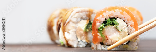 Homemade Sushi roll with salmon and cream cheese, banner.