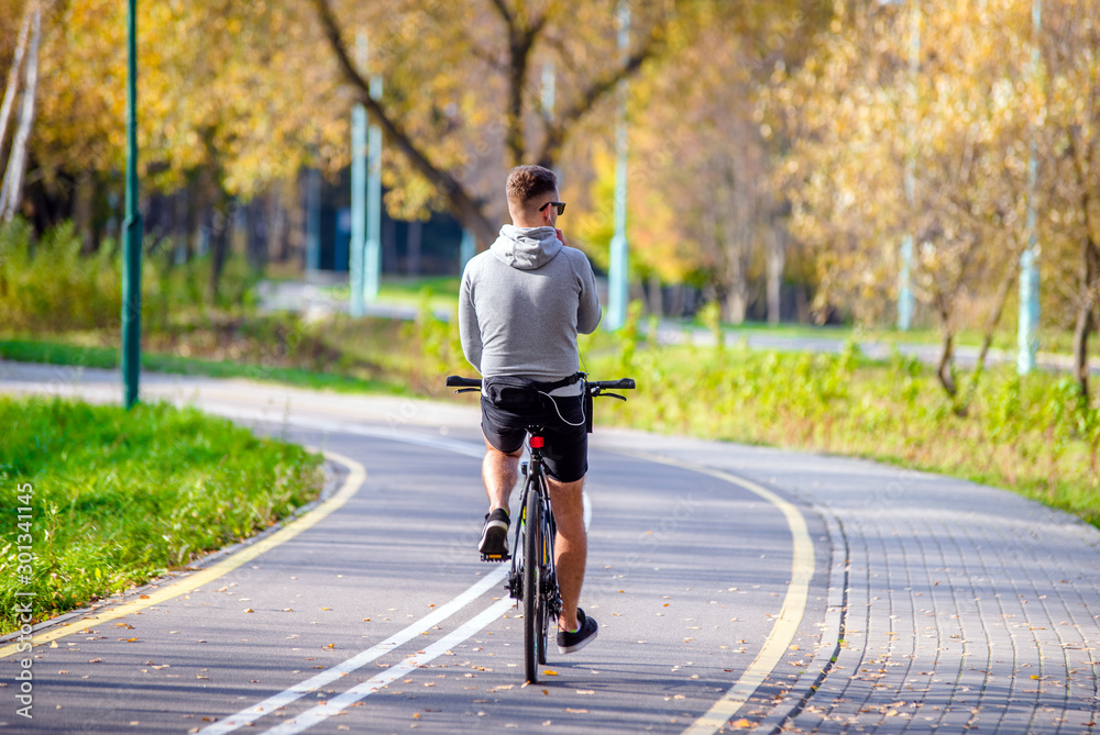 Fototapeta premium Cyclist ride on the bike path in the city Park