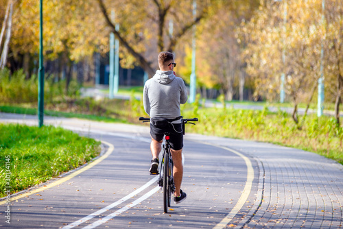 Wallpaper Mural Cyclist ride on the bike path in the city Park Torontodigital.ca