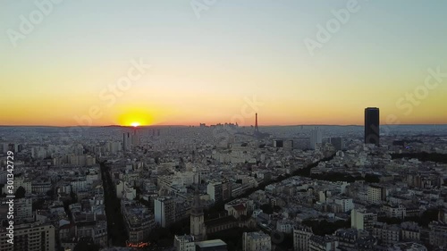 Aerial drone shot view of sunset in Paris with Eiffel tower and Tour montparnasse in the background photo