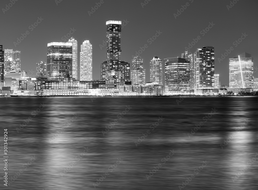 Black and white picture of Jersey City skyline at night.
