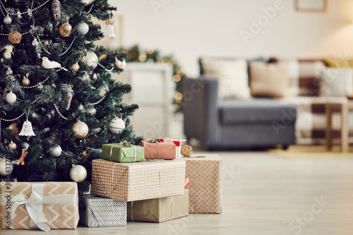 Canvas Print Image of decorated Christmas tree with gift boxes under it on the floor in the l