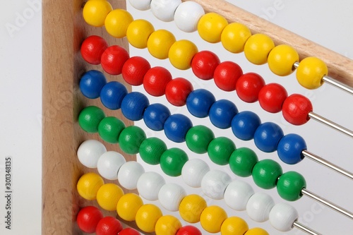 small ruler with colorful wooden balls in a white studio