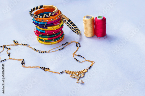 Traditional Indian thread bangles, silk thread earrings and Mangal sutra photo