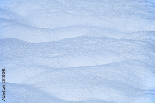Snow texture. Natural winter background with snow waves