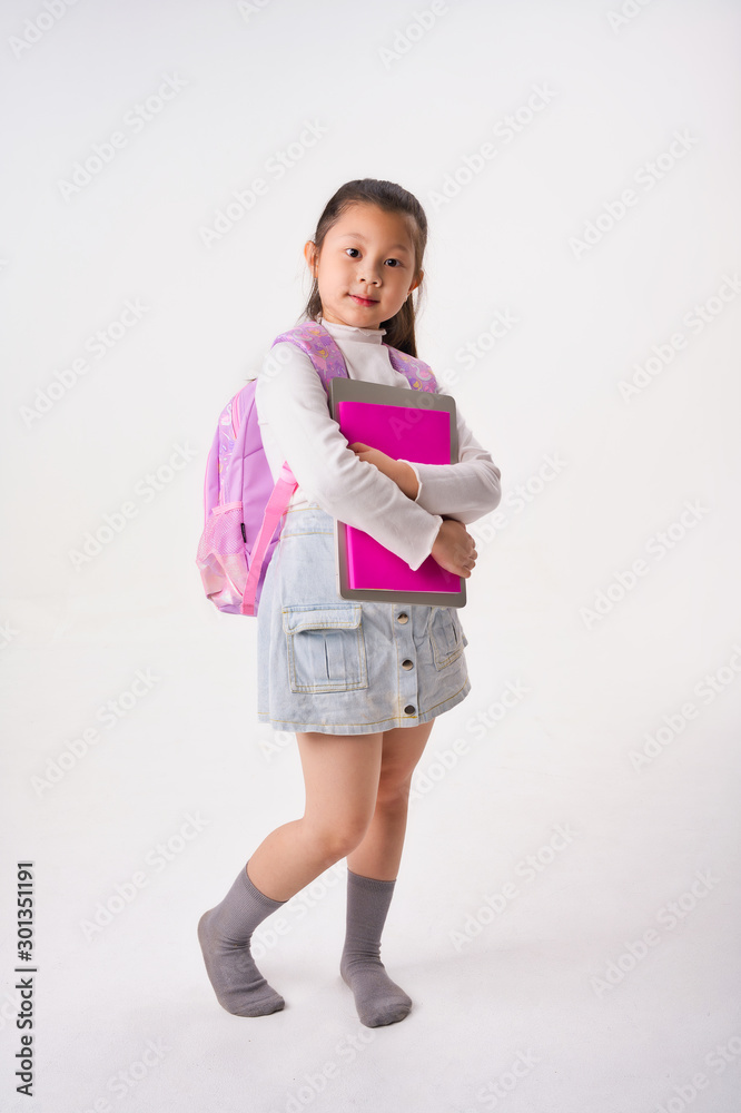 Asian Little girl hold study book and laptop on white background, Education Concept