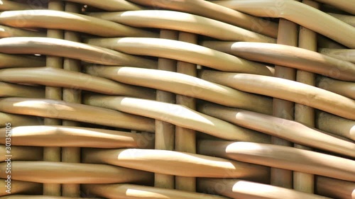 Shadow of bamboo trees moving on brown pattern background, artificial rattan material furniture. Close up outdoor wickerwork furniture with many dirty dust in natural daylight. Abstract and patterns c