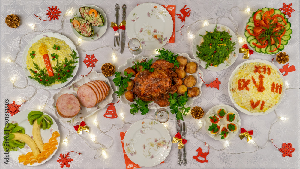 Festive Christmas served table with delicious food and decorative items. Dinner for New Year party, Christmas turkey. Winter holiday celebration at cozy home. Top view Festive Christmas served table with delicious food and decorative items. Dinner for New Year party, Christmas turkey. Winter holiday celebration at cozy home. Top view