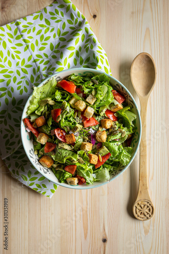 salad with tomatoes and avocado, top-view vertical