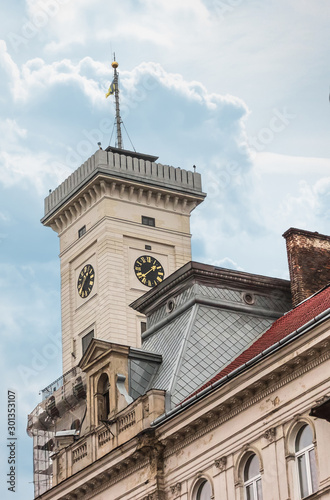 Old Tower Clock In Europe. Clock Face With Roman Numerals And Arrows. photo