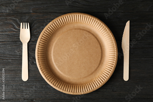Eco - friendly tableware on wooden background, top view and space for text