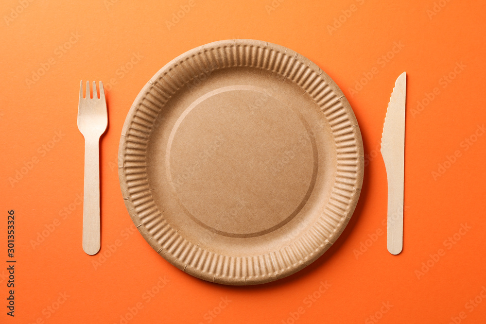 Flat lay with eco - friendly tableware on orange background, space for text Flat lay with eco - friendly tableware on orange background, space for text