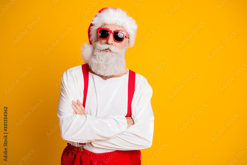 Portrait of serious santa claus from noel north-pole in red hat cross hands look confident on x-mas newyear party isolated over shine color background