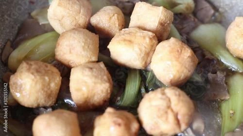 japanese fried tofu with chinese cabbage (pak choi) on saucepan, healthy recipe