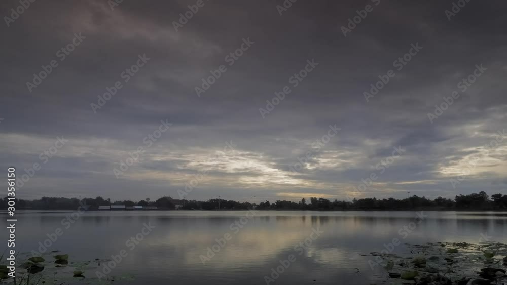 Time lapse of dark clouds moving above the lake with rain storm in the sky background, Krajub reservoir, Nonk Kop in Ban Pong District, Ratchaburi, Thailand. Time lapse of dark clouds moving above the lake with rain storm in the sky background, Krajub reservoir, Nonk Kop in Ban Pong District, Ratchaburi, Thailand.