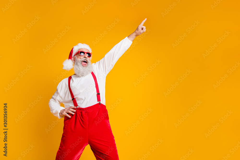 Portrait of funny crazy santa claus hipster in red hat fun christmas x-mas party celebrate newyear time dance raise index finger wear shirt suspenders isolated yellow color background - obrazy, fototapety, plakaty 