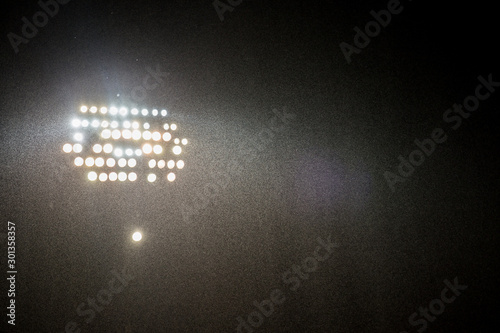 spotlights in the stadium by dark with rain