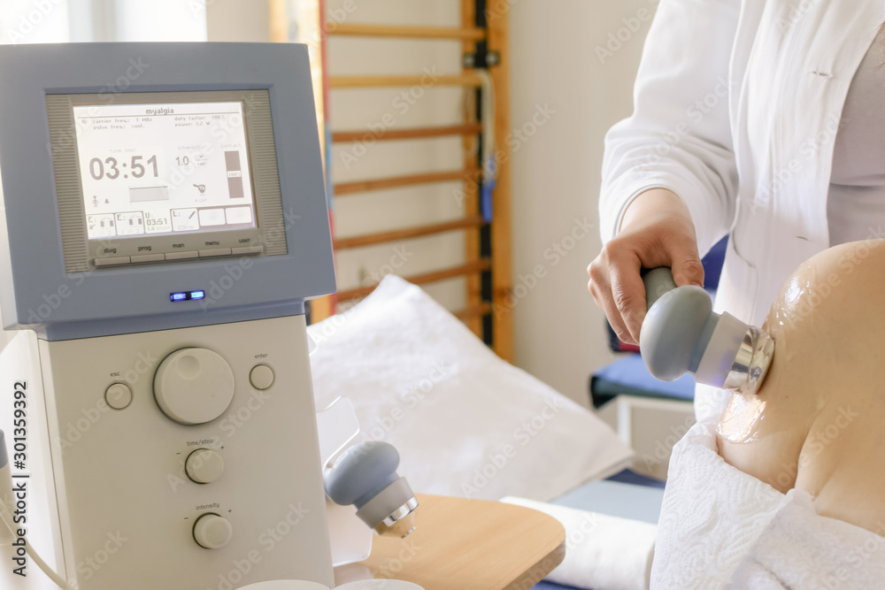 Ultrasound in Physical Therapy. Therapist Using Ultrasound Applicator