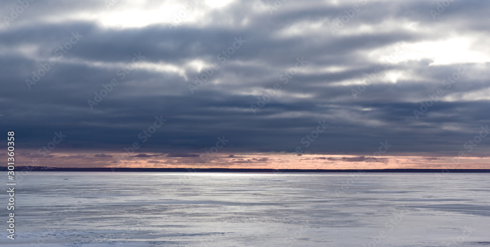 Sunset in winter on the shore of the frozen Baltic Sea