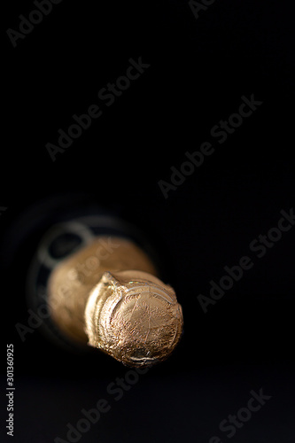 FRONT VIEW OF BOTTLE OF CHAMPAGNE ON BLACK BACKGROUND 2. CELEBRATION OF HOLIDAYS AND CHRISTMAS