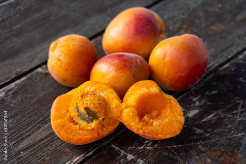 Close up of fresh apricots on an old black wooden table