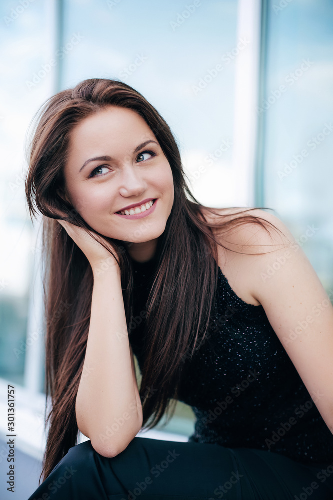 Portrait of beautiful brunette woman with makeup in fashion clothes