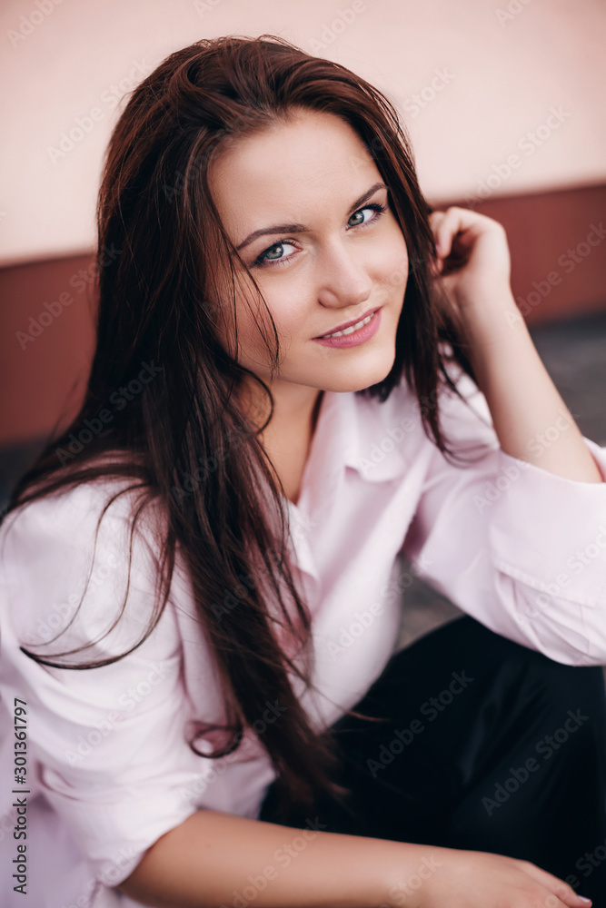 Portrait of beautiful brunette woman with makeup in fashion clothes Portrait of beautiful brunette woman with makeup in fashion clothes