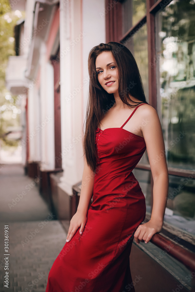 Portrait of beautiful brunette woman with makeup in fashion red clothes