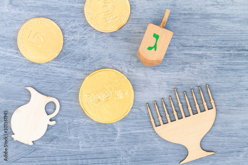 Close up of Hanukkah gelt or money or coins. Perfect for your Hanukkah holiday design. Translation of the hebrew text: Happy Holidays and Letter G photo