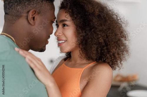 Fotografie Beautiful young couple looking at each other with love