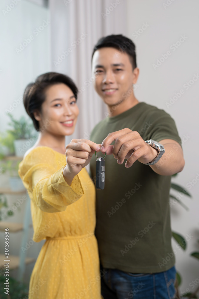 Portrait of young couple feeling happy about buying a new car Portrait of young couple feeling happy about buying a new car