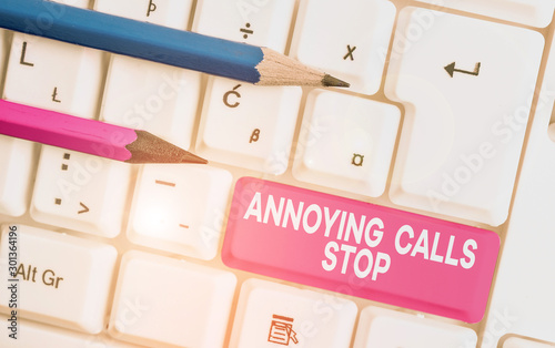 Text sign showing Annoying Calls Stop. Business photo text Prevent spam phones Blacklisting numbers Angry caller White pc keyboard with empty note paper above white background key copy space