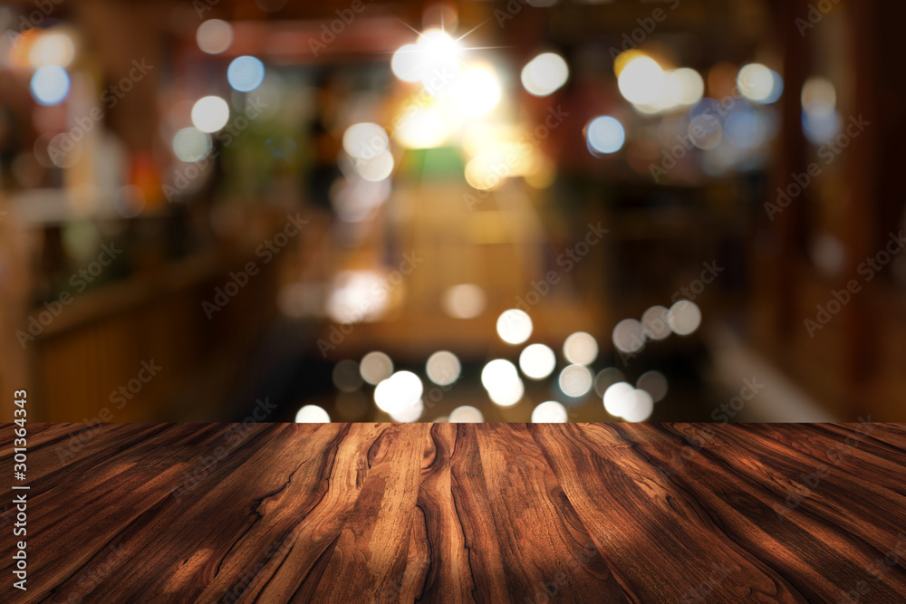 top desk with blur restaurant background,Wooden table and blurred bokeh of night street background