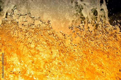 splashing water like beer or chrystal close up photo