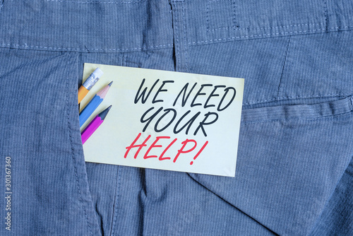 Writing note showing We Need Your Help. Business concept for asking someone to stand with you against difficulty Writing equipment and yellow note paper inside pocket of man trousers