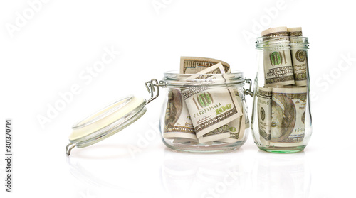 Dollar bills in glass jar on white background.money saving financial concept.