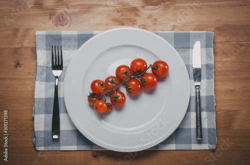 Cherry tomatoes on white plat
