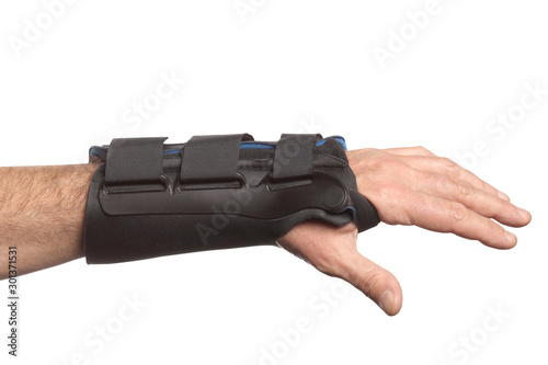 human hand with a wrist brace, orthopedic equipment isolated on white background with clipping path and copy space for your text photo