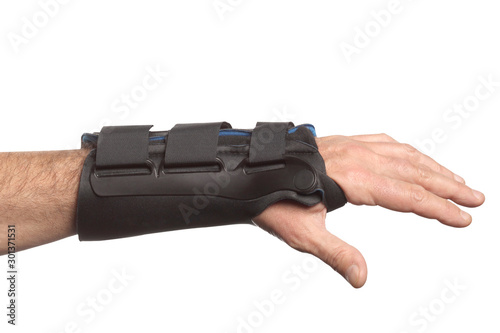 human hand with a wrist brace, orthopedic equipment isolated on white background with clipping path and copy space for your text