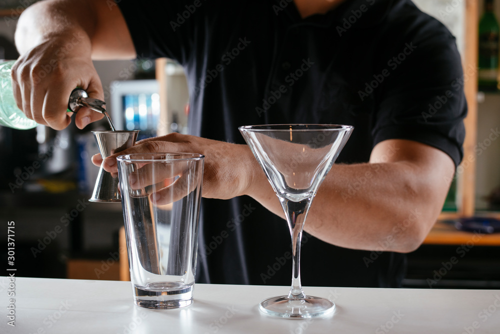 Barman making cocktail on bar counter