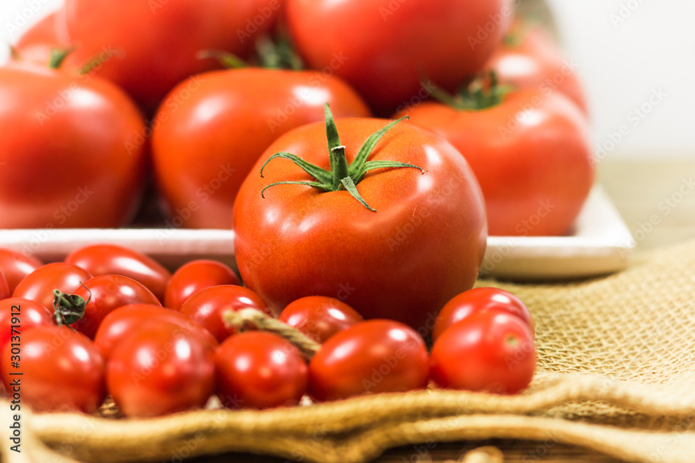 chery tomatoes on wooden board with linen sack, selective focus chery tomatoes on wooden board with linen sack, selective focus