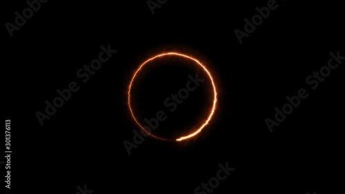 Ring of neon gold fire light circle spinning around in a progress loop on a black background - looped