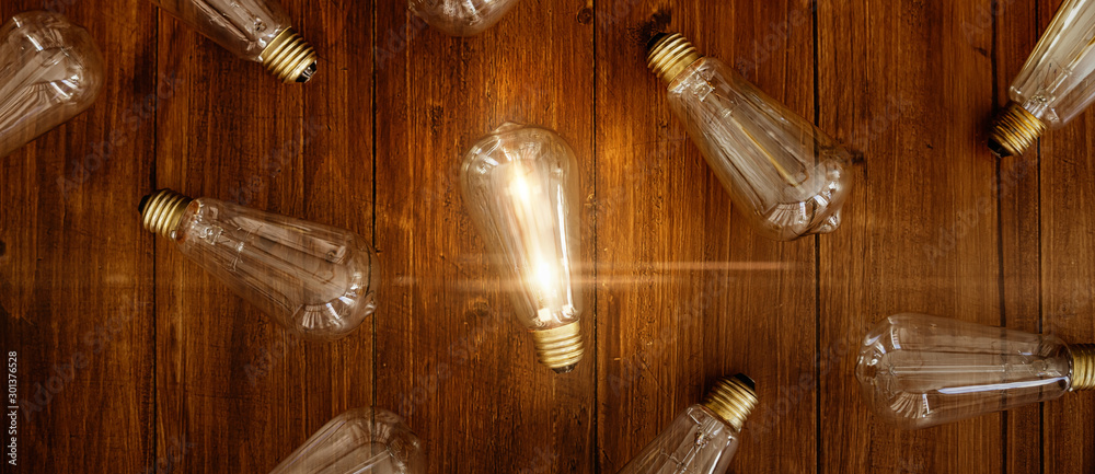 Glowing bulb. Idea, uniqueness, leadership and difference concept. - obrazy, fototapety, plakaty 