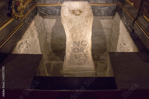 Padron, Spain - 10/20/2018: ancient relic with roman letters as part of Saint Jacob's miracles in Padron cathedral, Galicia, Spain. Camino de Santiago heritage. Famous historical pillar in church.   photo