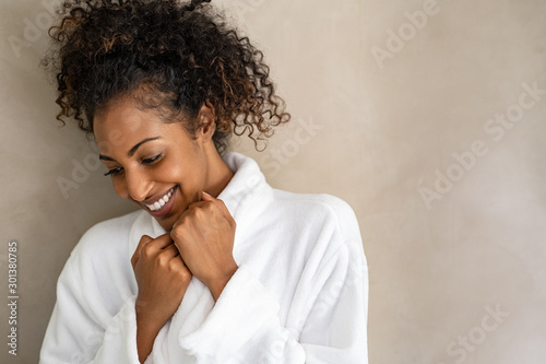 African young woman in bath robe at spa