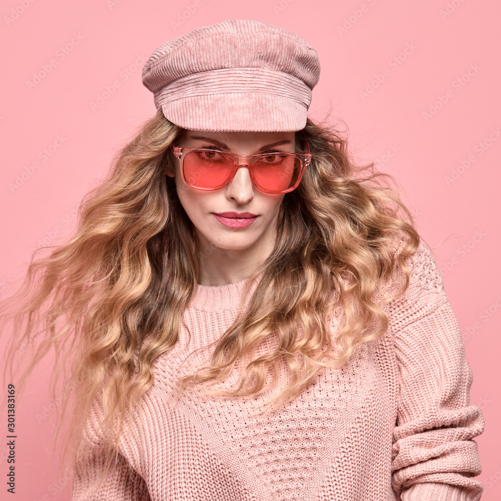 Fashionable lovable woman in Trendy pink outfit, stylish hairstyle, makeup smiling. Young blonde in jumper. Sensual beautiful model girl in stylish sunglasses, pastel fashion beauty concept on pink Fashionable lovable woman in Trendy pink outfit, stylish hairstyle, makeup smiling. Young blonde in jumper. Sensual beautiful model girl in stylish sunglasses, pastel fashion beauty concept on pink