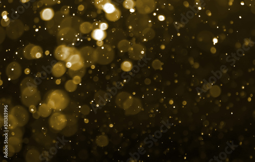 gold powder bokeh light  blur circles on black background